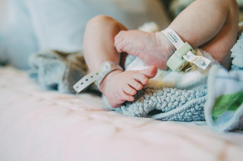 new born baby feet with hospital tags