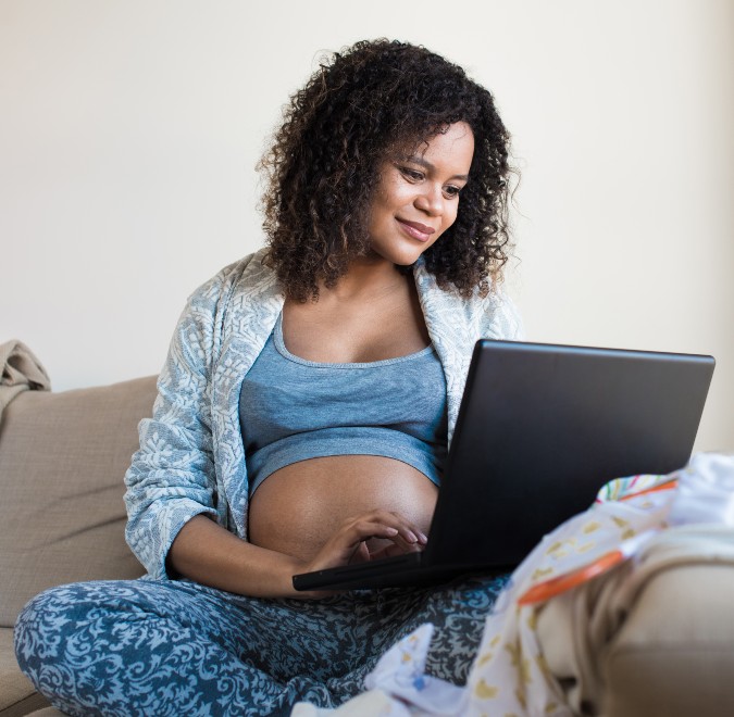 pregnant woman on computer researching covid-19 vaccine information